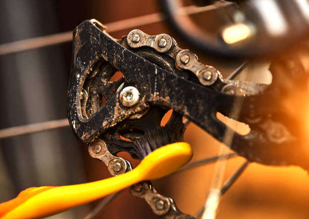Cleaning the rear sprocket by a toothbrush at on the derailleur of a sporty bicycle with gears stock photo