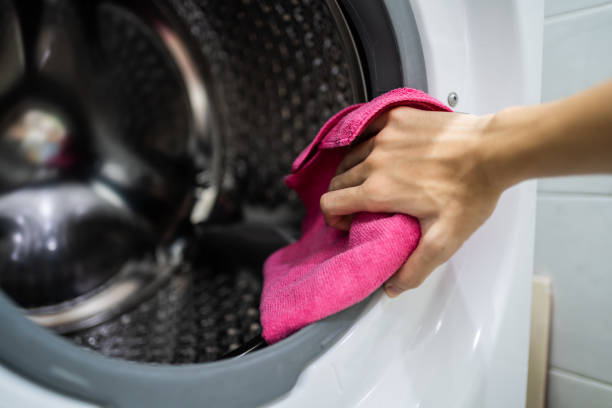 Cleaning washing machine with cloth stock photo