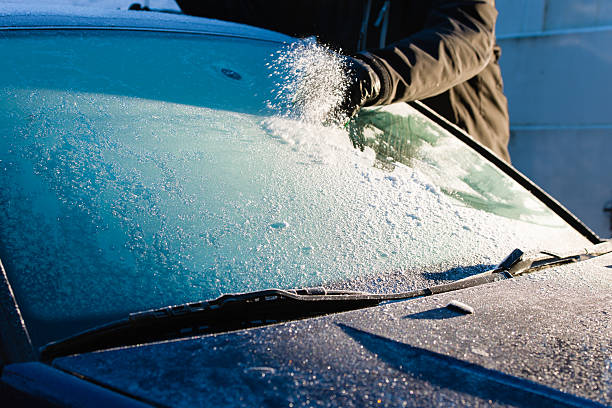 Cleans frozen windshield stock photo