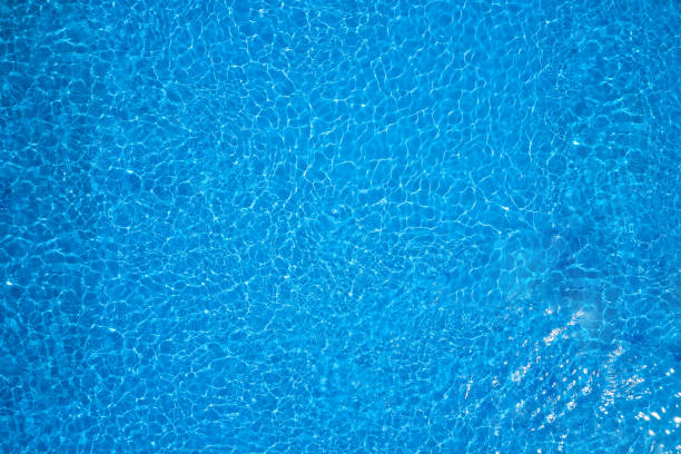 Clear blue swimming pool water Abstract blue water surface background texture standing water stock pictures, royalty-free photos & images