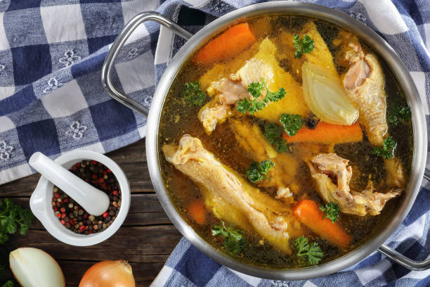clear Chicken broth in a pot stock photo