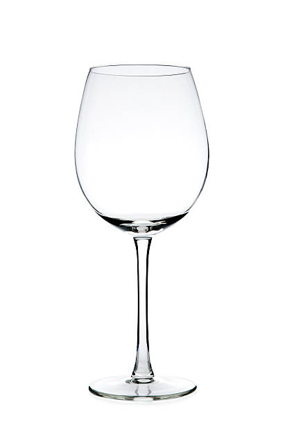 Clear empty wine glass against a white background stock photo