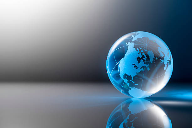 Clear glass globe on gray table backround. stock photo