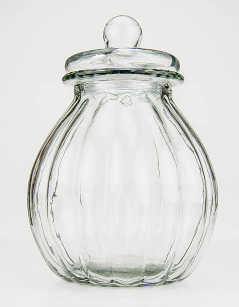 Clear Vintage Glass Jar on White A rounded vintage glass jar on a white background candy jar stock pictures, royalty-free photos & images