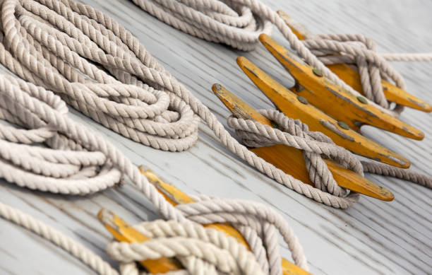 Cleats and Ropes on a Wooden Sailboat Deck stock photo
