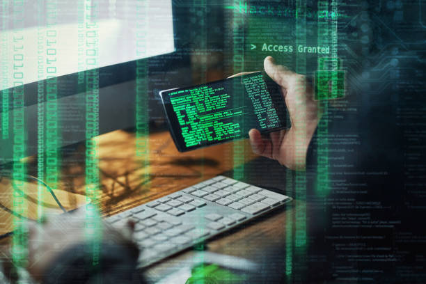 Click click and you're hacked Cropped shot of an unidentifiable hacker cracking a computer code in the dark spyware stock pictures, royalty-free photos & images
