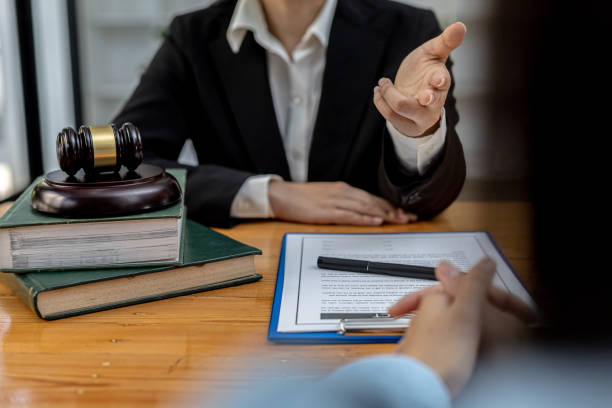 Client was listening to a lawyer advising on an embezzlement case, explaining the details of the proceeding and gathering evidence to file a lawsuit against the defendant. The concept of litigation. stock photo