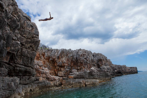 Cliff diving Veslo, Montenegro - May 23rd 2019: Cliff diving in summer 2019 cliff jumping stock pictures, royalty-free photos & images