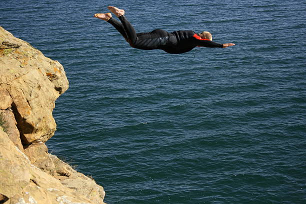 Cliff jump A man jumping off a cliff cliff jumping stock pictures, royalty-free photos & images