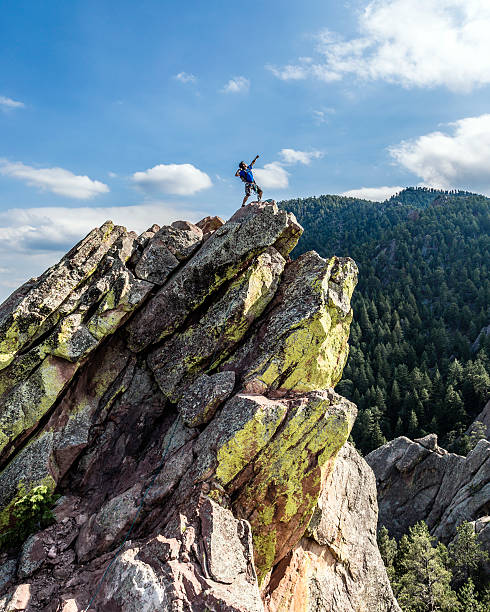 Climber Posing on top of Mountain stock photo