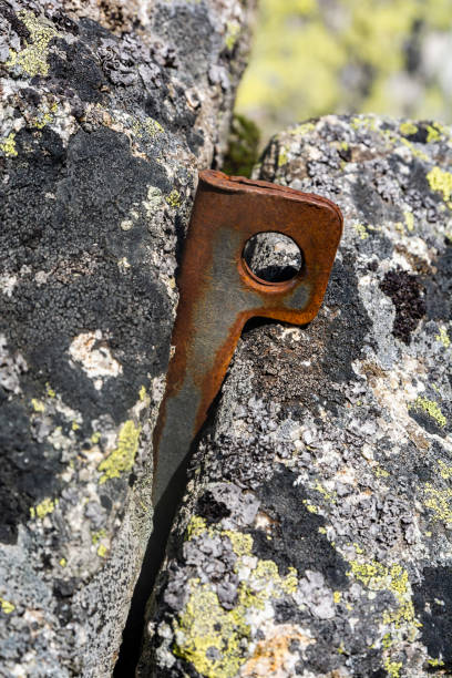 Climbing protection - Angle – A piton made of steel sheet bent into V shape. Work well for larger cracks, where the steel deforms elastically as the piton is placed. Climbing protection - Angle – A piton made of steel sheet bent into V shape. Work well for larger cracks, where the steel deforms elastically as the piton is placed. anchor point stock pictures, royalty-free photos & images
