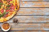 Pepperoni Pizza on wooden table with space on text. Top view
