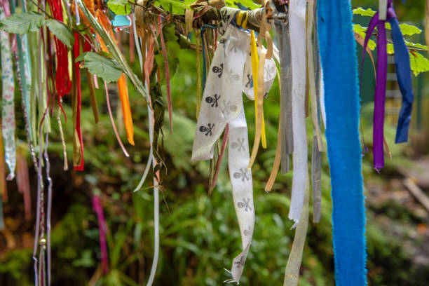 Clootie tree in Cornwall Clootie Tree at St Nectans Glenn near Tintagel in north Cornwall. Clootie Wells are places of pilgrimage in Celtic areas. Strips of cloth or rags are usually tied to a branch as part of a healing ritual. thomas wells stock pictures, royalty-free photos & images