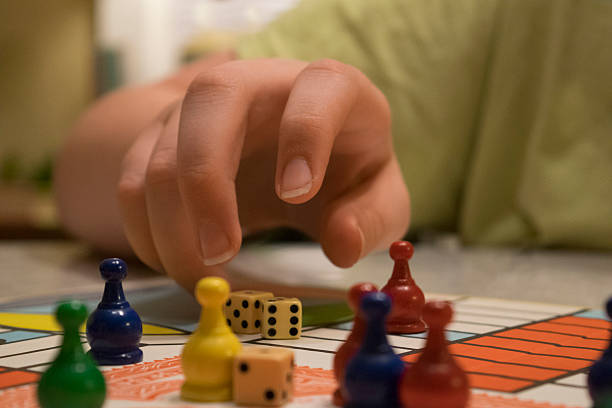Close shot of dice and tokens on a game board stock photo
