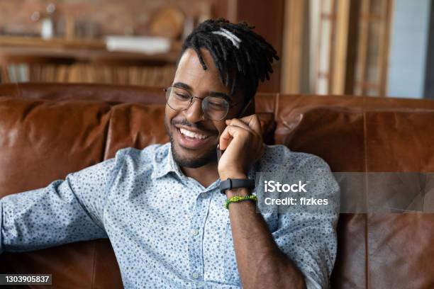 Close up African American man wearing glasses talking on phone