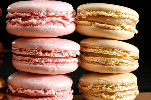 Close up shot of traditional assorted french dessert of fresh colorful macarons in a row