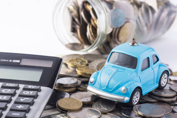Close up blue car with calculator and coin. Selective focus in car. Concept for car insurance and financial. car loan stock pictures, royalty-free photos & images