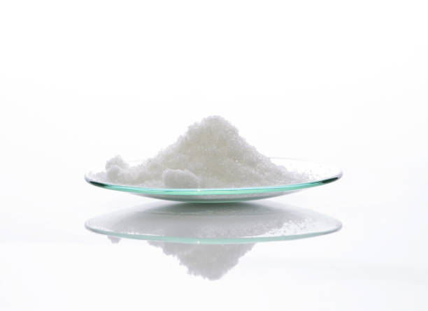 Close up chemical ingredient on white laboratory table. Di-Ammonium Prosphate in Chemical Watch Glass. Side View stock photo