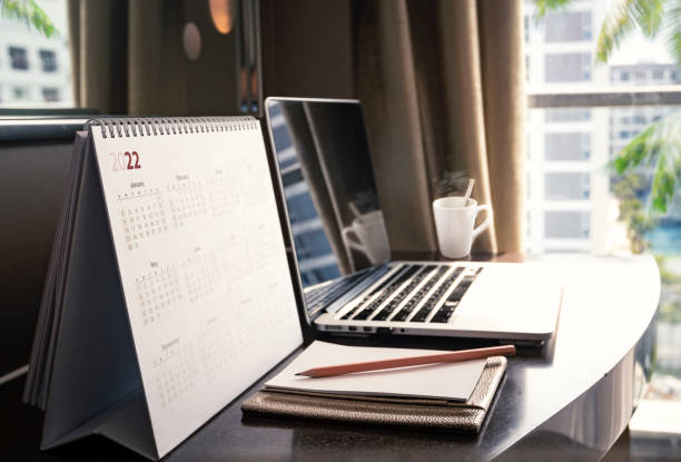 Close up desktop calendar 2022 on wooden desk stock photo