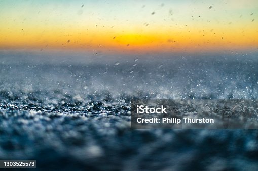 istock Close up details and textures of rain on surface of ocean 1303525573