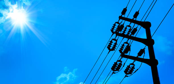 close up electricity power line tower over blue sunny sky close up electricity power line tower over blue sunny sky with shining sun power cable stock pictures, royalty-free photos & images