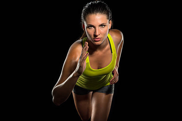Close up female jogger sprint runner determined athlete training fitness stock photo