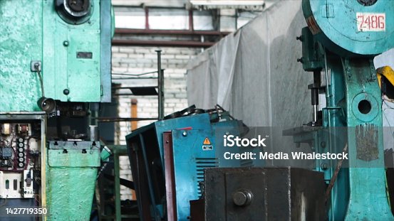 istock Close up for woodworking factory machines. Metal machine tools looking old at a workshop, factory concept. 1427719350