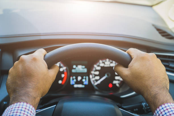Close up front view hands hold steering wheel. Driving car concept. stock photo