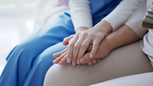 Close up hand of young asia woman or nurse home care holding senior grandmother give support empathy to elderly lady or older people in assisted living homecare mental health relief concept. stock photo
