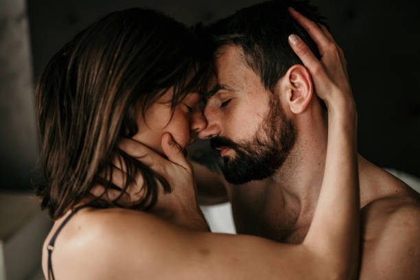 Close up image of a couple in bed with eyes closed stock photo