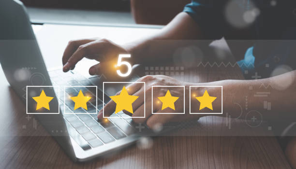 Close up man using Lap top for rating feedback from customer service with annual survey with five gold star icon. Business annual satisfaction survey concept. User reviews and feedback online. stock photo