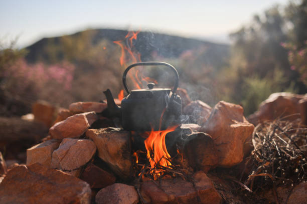 A close up of a camping kettle on an open fire stock photo