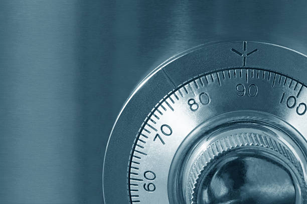 A close up of a combination lock on a safe Combination safe lock, close-up view, in cyan tone.   http://robynm.smugmug.com/photos/175514497-L.jpg  safes and vaults stock pictures, royalty-free photos & images