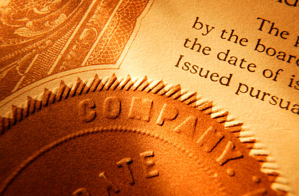 Close up of a company seal on old stock certificate Close up of  company seal from a stock certificate. stock certificate stock pictures, royalty-free photos & images