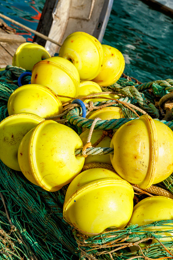 Close up of a fishing net and fishing devices used in the fishing industry. Image taken in a harbor. Fishing backgrounds