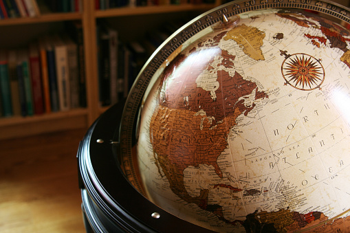 Old-fashioned looking globe in a home library, showning North America and the Atlantic Ocean