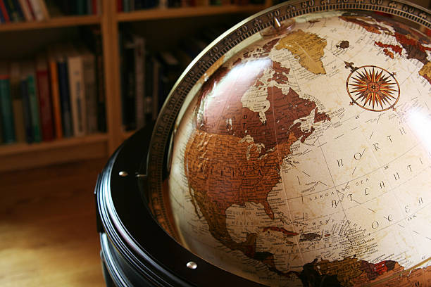 Close up of a globe in a library Old-fashioned looking globe in a home library, showning North America and the Atlantic Ocean globe navigational equipment stock pictures, royalty-free photos & images