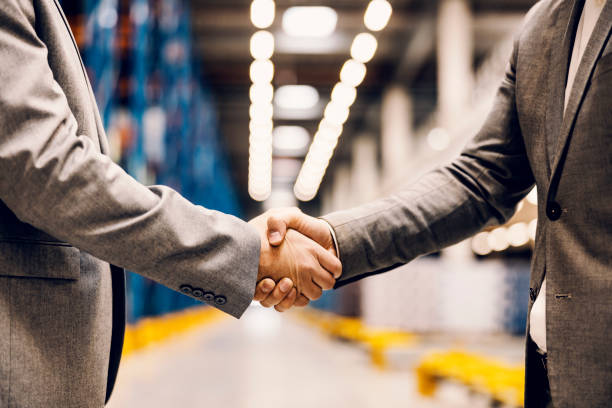 Close up of a handshake of business partners at storage. stock photo