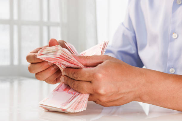 Close up of a man's hand counting money stock photo