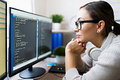 istock Close up of a smart young woman coding 1332378618