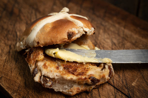 Close up of a toasted buttered Hot Cross bun. stock photo