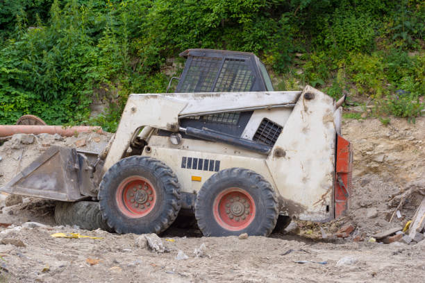 A close up of a white bobcat s550 or skid loader on construction site. A close up of a white bobcat s550 or skid loader on construction site bobcat stock pictures, royalty-free photos & images