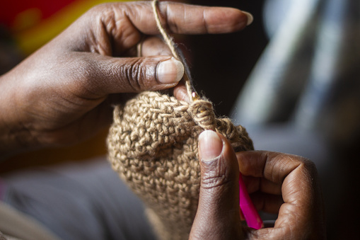 Close up of a woman's hand crocheting