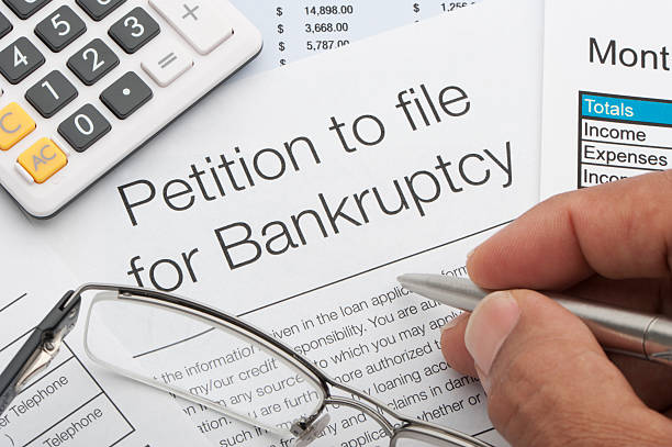 Close up of bankruptcy petition Close up of bankruptcy petition with calculator and writing hand bankruptcy stock pictures, royalty-free photos & images