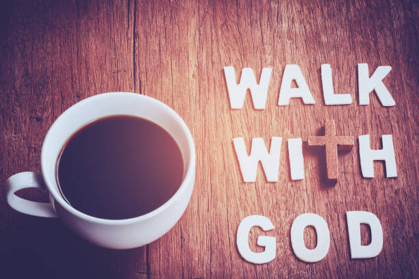 Close up of black coffee with the word " walk with God " design by white letterpress on wooden background, Vintage tone stock photo