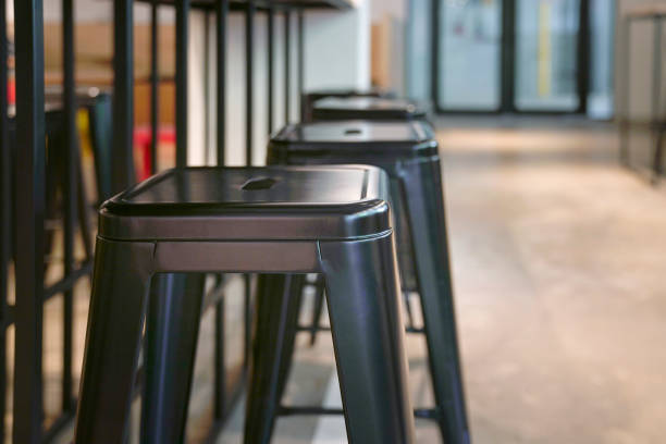 Close up of black metal stools in an empty restaurant. stock photo