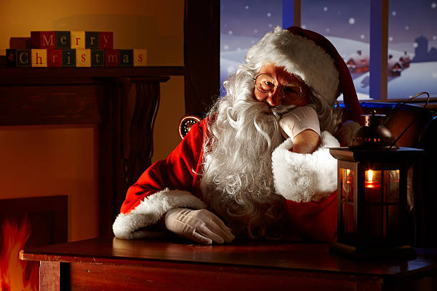 close up of bored Santa sitting in his grotto stock photo