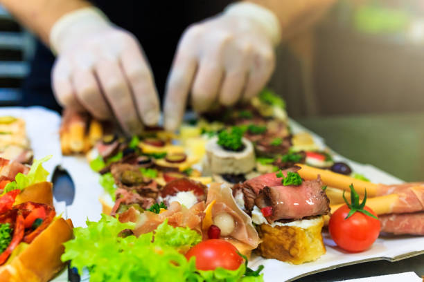 Close up of chef preparing food appetizers canape snacks catering concept. Buffet meal preparation and serving at restaurant. food and beverage industry stock pictures, royalty-free photos & images