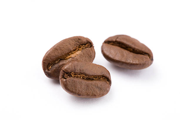 Close up of coffee beans against white background stock photo