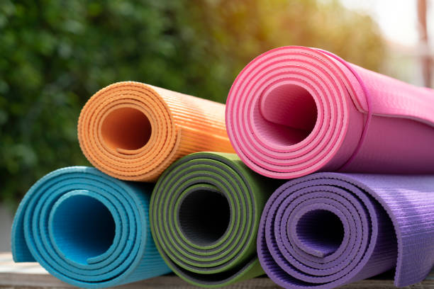 close up of colorful yoga mat on the table, sport and healthy concept stock photo